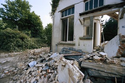 David De Lossy/Photodisc/Getty Images Get repair estimates before bidding on abandoned property.