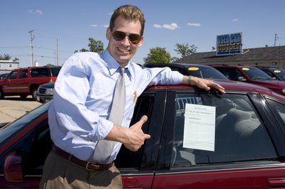 Creatas/Creatas/Getty Images You can often find salvage title cars at a used-car dealership.