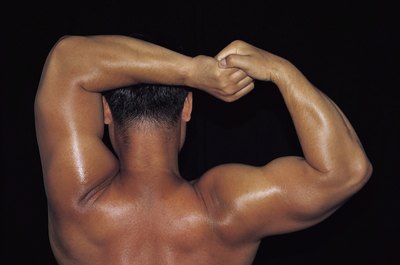 Jupiterimages/Photos.com/Getty Images Overbuilding your upper arms can affect range of upper arm motion.