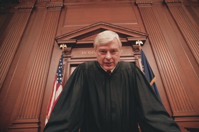 Comstock/Comstock/Getty Images Judges can hold uncooperative debtors in contempt.