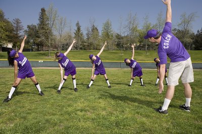 Jupiterimages/Brand X Pictures/Getty Images Stretches improve the flexibility and performance of all softball players.