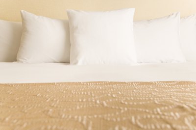 Jupiterimages/Comstock/Getty Images Adding a headboard doesn't have to be expensive.