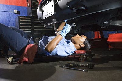 Jupiterimages/Comstock/Getty Images Diesel mechanics may have to maintain awkward positions to make repairs.