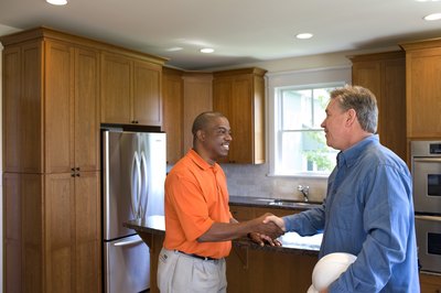 David Sacks/Lifesize/Getty Images Contractors manage the work done in your home.