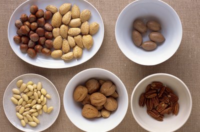 Creatas Images/Creatas/Getty Images Peanuts and tree nuts provide linoleic acid and cholesterol-lowering phystosterols.
