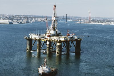 Jupiterimages/liquidlibrary/Getty Images Travel is one of the perks of a petroleum engineer.