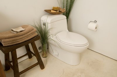 Jupiterimages/Photos.com/Getty Images Strict environmental laws require toilets to flush using less than two gallons of water.