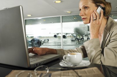 John Rowley/Digital Vision/Getty Images The aviation consultant confers with the management for the best operational analysis strategies.