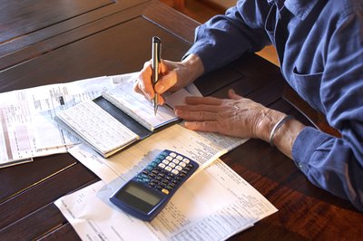 Thinkstock/Comstock/Getty Images With consent, it's simple to remove your wife's name from a checking account.