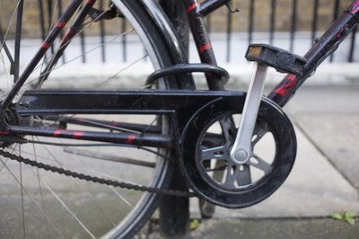 Jupiterimages/Polka Dot/Getty Images With proper gear adjustment, pedaling offers a challenging workout.