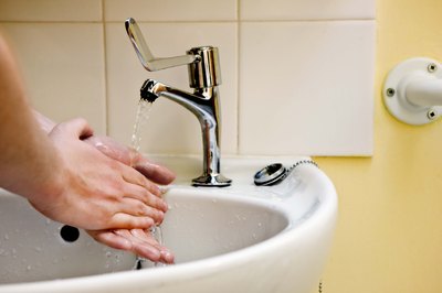 Jupiterimages/BananaStock/Getty Images Water from hand washing can be used to water the lawn.