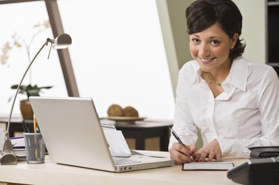 Jupiterimages/Comstock/Getty Images The check you write to a charity can mean less tax for you.