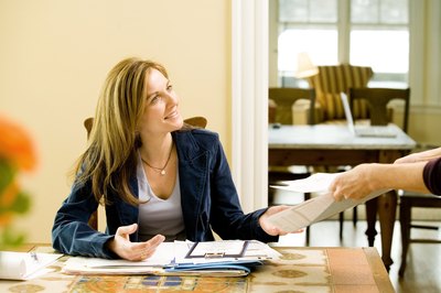 Jupiterimages/Photos.com/Getty Images An executive secretary does much more than type and answer the phone.