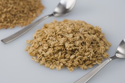 Jupiterimages/Comstock/Getty Images Oat bran and rolled oats provide protein and fiber that help satisfy your appetite.