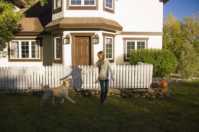 Comstock Images/Comstock/Getty Images Play with your dog to help prevent her from wanting to escape.