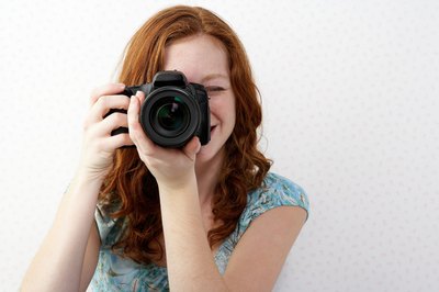 Jupiterimages/Photos.com/Getty Images A photographer's job involves much more than taking a photo.