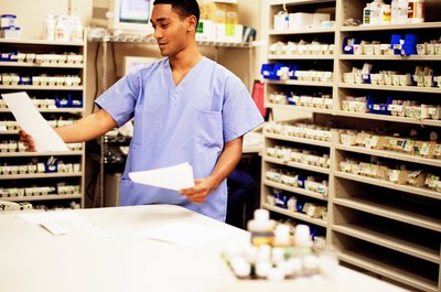 Jupiterimages/Photos.com/Getty Images Pharmacy techs prepare and label prescriptions for patients.