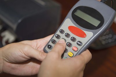 Jupiterimages/Goodshoot/Getty Images Chip-and-PIN machines have been shown to cut physical card fraud.