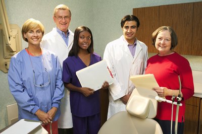 Thinkstock Images/Comstock/Getty Images Each staff member of a dentist's office has a distinctly different role.