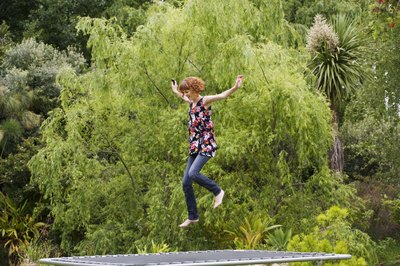 Jupiterimages/BananaStock/Getty Images Jumping on a trampoline is a good way to mix up your workout routine.