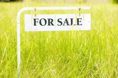 Jupiterimages/Photos.com/Getty Images Buying vacant land is cheaper and allows you to build from scratch.