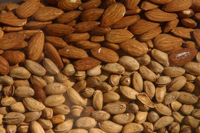 Hemera Technologies/AbleStock.com/Getty Images Nuts supply small amounts of fiber.