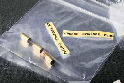 Jupiterimages/liquidlibrary/Getty Images Crime scenes are common spots for on-the-job forensic ballistics analysts.