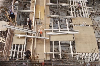 Hemera Technologies/AbleStock.com/Getty Images Apartment construction can be very expensive.