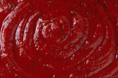 Brand X Pictures/Brand X Pictures/Getty Images Tomato paste contains lycopene, a healthy, natural compound.