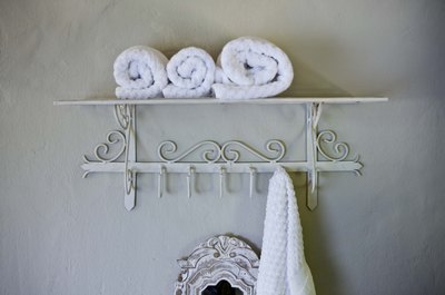 Jupiterimages/BananaStock/Getty Images Shelving can help you save space and add design to your bathroom.