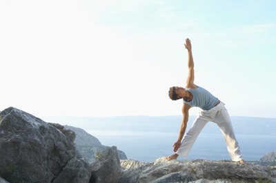Janie Airey/Stockbyte/Getty Images Performing Triangle pose with a partner instead of solo can help you gain a deeper more intense stretch from this asana.