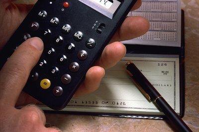 Jupiterimages/Photos.com/Getty Images A personal budget begins with calculating your monthly income and expenses.
