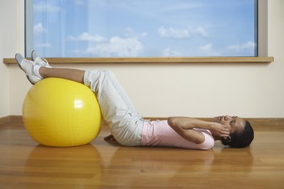 Jupiterimages/Creatas/Getty Images The stability ball leg curl works a variety of muscles.