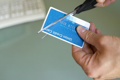 Creatas/Creatas/Getty Images Just cutting up a credit card doesn't close an account.