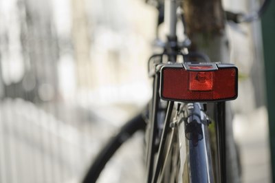 Jupiterimages/Polka Dot/Getty Images Whether it's the law or not, fit your bike with reflectors.