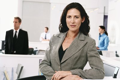 Digital Vision./Photodisc/Getty Images Demotion from salary to hourly status is complex.