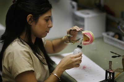 Joe Raedle/Getty Images News/Getty Images The dentures people wear were crafted at the hands of a dental technician.