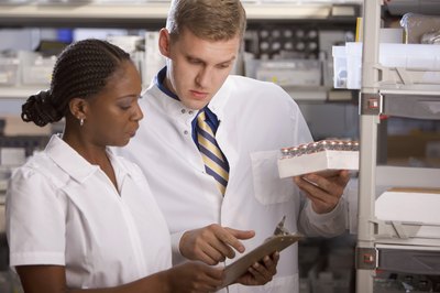 Medioimages/Photodisc/Digital Vision/Getty Images Lab technicians work and closely analyze test results.