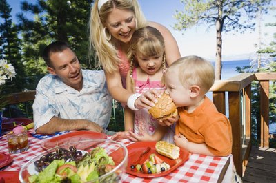 Creatas Images/Creatas/Getty Images Eat meals with your infant and include him at the dinner table.