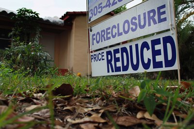 Joe Raedle/Getty Images News/Getty Images Hire a sales agent or visit bank and government websites to see foreclosures.