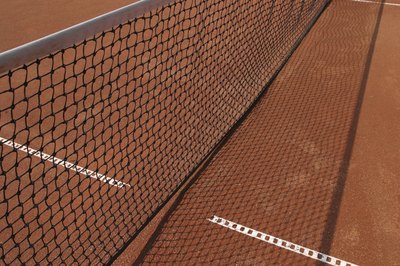 Hemera Technologies/AbleStock.com/Getty Images The rules of tennis dictate when to switch sides of the court.