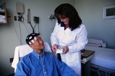 Keith Brofsky/Photodisc/Getty Images EEG technicians run tests to monitor brain wave activity.