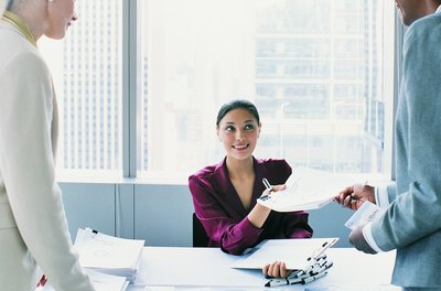 Digital Vision./Digital Vision/Getty Images Meeting planners prepare all aspects of professional meeting and events.