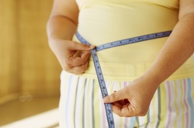 George Doyle/Stockbyte/Getty Images Use both diet and exercise strategies to lose rib fat.