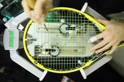Dan Kitwood/Getty Images Sport/Getty Images Stringing your own rackets can save you money.