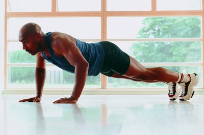 Stockbyte/Stockbyte/Getty Images The standard pushup works the upper body.