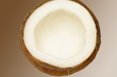 Medioimages/Photodisc/Photodisc/Getty Images Dried coconut flesh is the source of coconut oil.