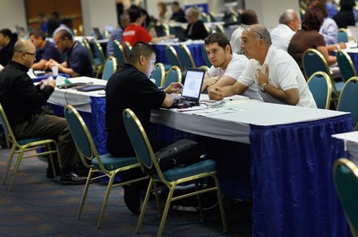 Joe Raedle/Getty Images News/Getty Images Bank representatives are helping people with their mortgages.