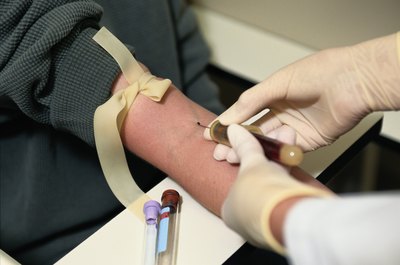 Keith Brofsky/Photodisc/Getty Images Phlebotomists work with tourniquets, syringes and other medical equipment.