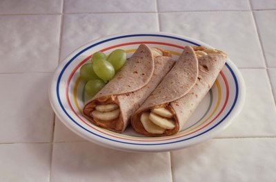 Jupiterimages/Comstock/Getty Images Go for whole-wheat products to bump up your fiber intake.